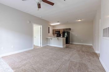 A room with a ceiling fan and a desk with a computer.